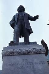 401200: Ottawa ON Canada Statue of Thomas D'  Arcy McGee at rear of Houses of Parliament