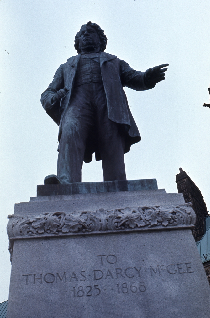 401200: Ottawa ON Canada Statue of Thomas D'  Arcy McGee at rear of Houses of Parliament